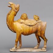 A Chinese pottery Tang style camel Naturalistically modelled with allover mustard glaze, standing on
