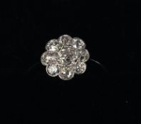 An 18 ct white gold daisy head set diamond ring