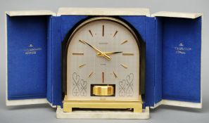 A brass cased Jaeger LeCoultre Atmos clock The domed case with bands of scrolling decoration, housed