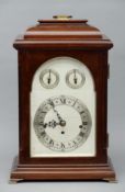 A mahogany cased bracket clock The stepped domed top with a brass carrying handle, the silvered dial