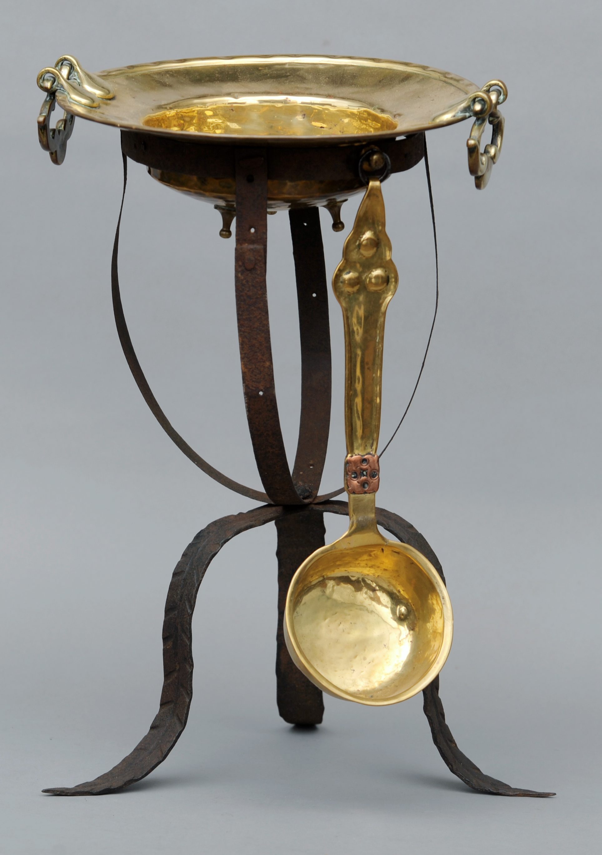 An Iberian brass and wrought iron twin handled brazier on stand and ladle 46 cms high overall.