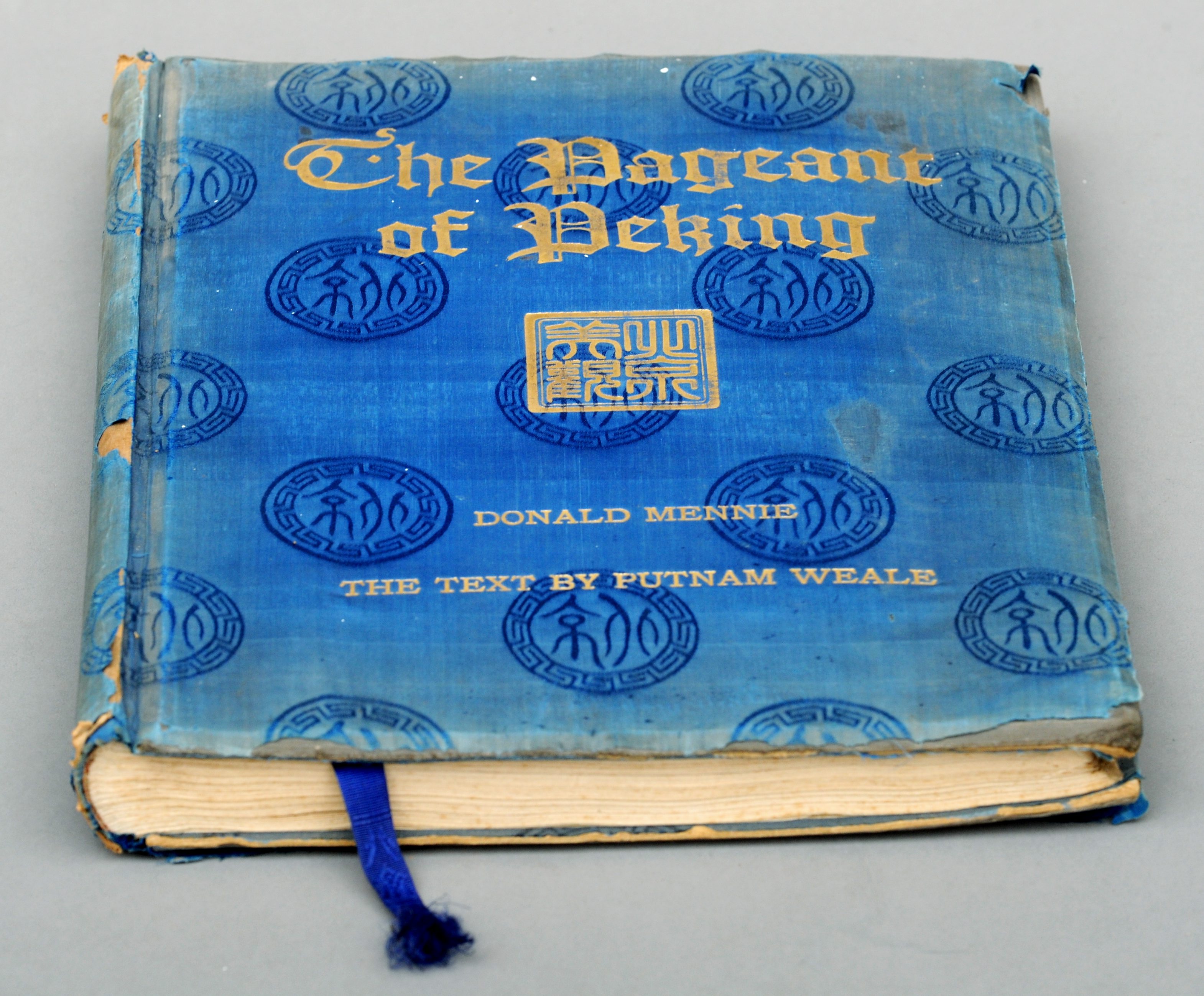 Mennie, Donald. The Pageant of Peking. Published 1920 by A.S. Watson & Co., Shanghai, gilt blue silk