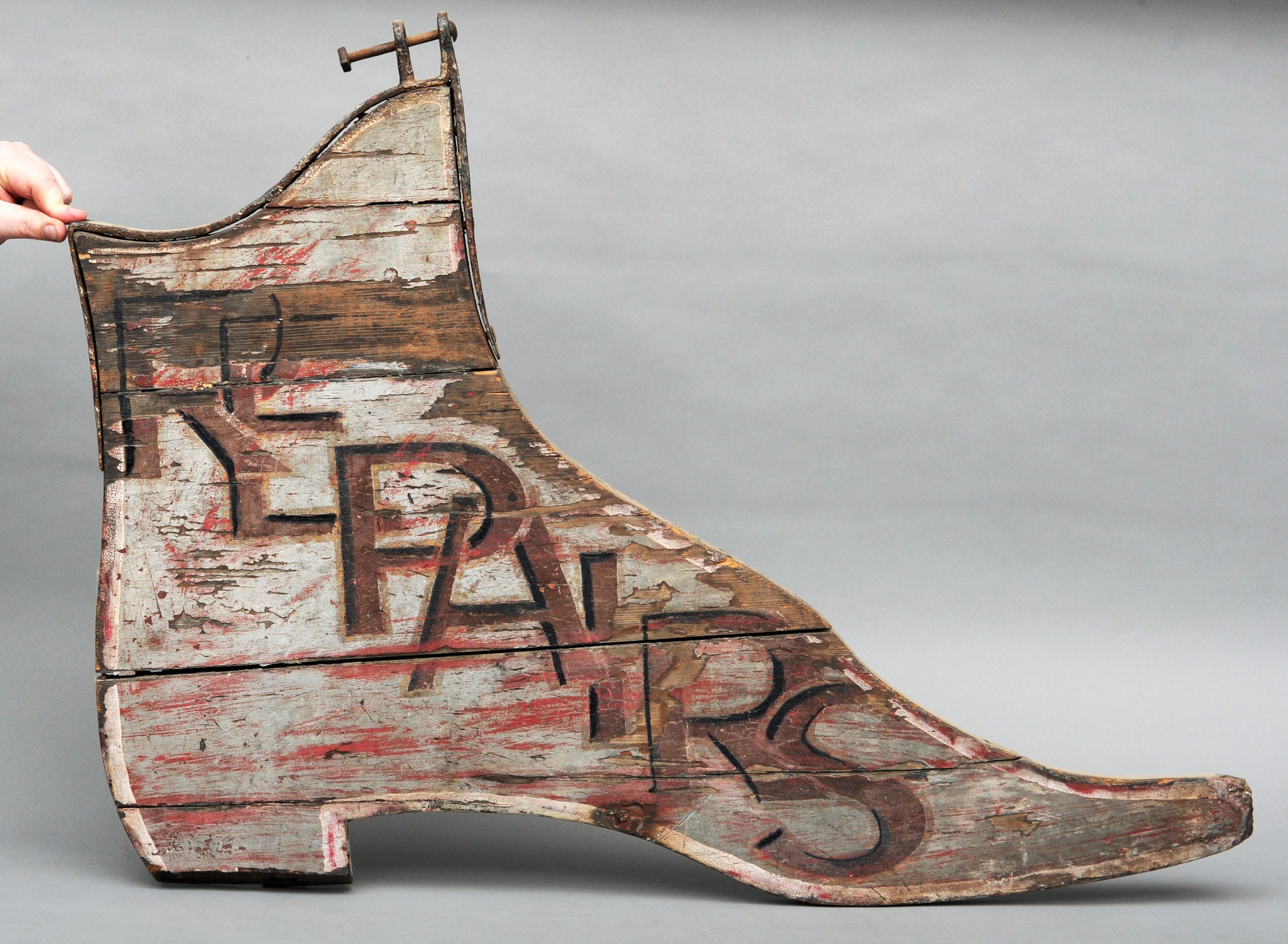 A 19th century double-sided painted wood cobbler’s sign Modelled as a ladies boot and inscribed