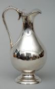 An Edwardian silver hot water jug, hallmarked London 1904, maker’s mark of SHB The hinged lid