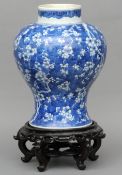 A 19th century Chinese porcelain vase Of inverted baluster form, decorated overall with prunus