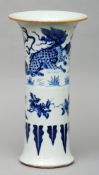 A Chinese porcelain blue and white gu vase Decorated with a dragon in a landscape and foliate