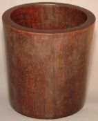 A Chinese turned hardwood brush pot 15. 5 cms high.Generally in good condition, expected wear,