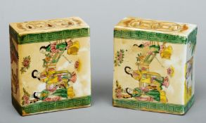 A pair of Chinese famille verte decorated flower bricks The pierced tops above scenes of figures