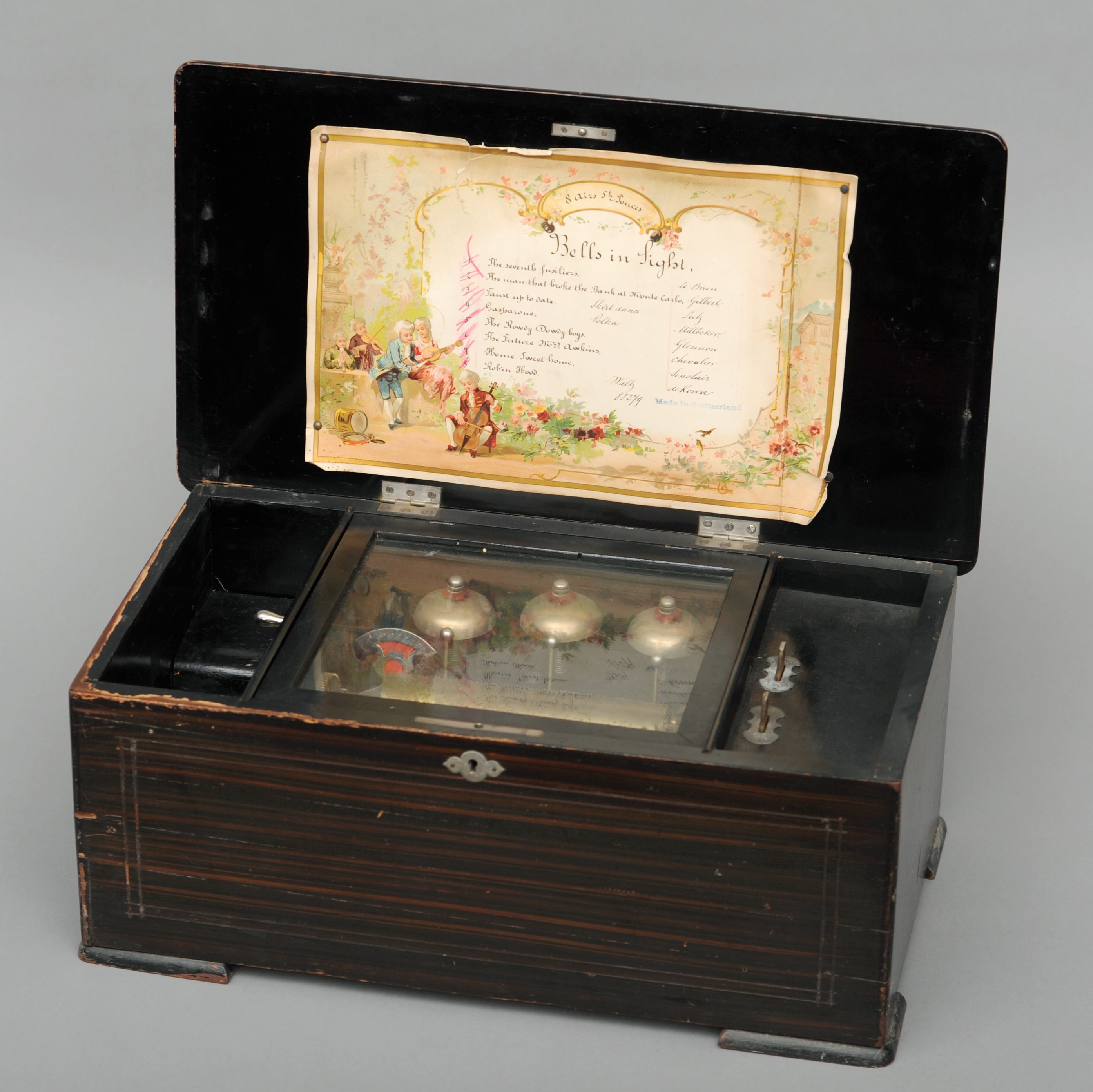 A 19th century Swiss music box With a transfer decorated painted wooden case enclosing the