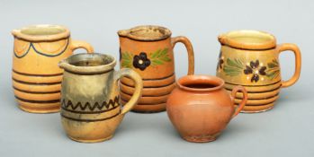 Five 19th century French pottery Provencal jugs Four typically slipware decorated with geometric