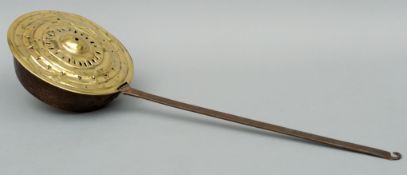 A 17th century brass and steel warming pan The flattened square section steel handle terminating