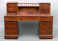 A Victorian mahogany “Dickens” desk The galleried back flanked by twin banks of drawers above a