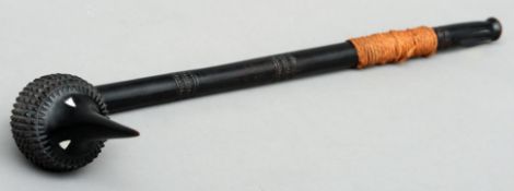 A Fijian ebonised Totokia Of typical spiked ball form. 59 cms long.Overall good with some wear.