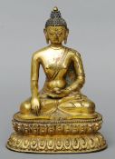 A 19th century Sino-Tibetan gilt bronze model of a deity Seated in the lotus position holding a