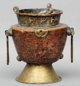 A 19th century Tibetan copper and brass incense burner The pierced body issuing two long loop