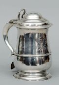 A George III silver lidded tankard, hallmarked London 1762, maker’s mark possibly for BC The domed