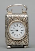 A Victorian silver cased miniature carriage clock The white enamelled dial with Roman numerals,