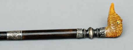 A Victorian walking cane The shaft mounted with an ornate white metal collar and a carved horn