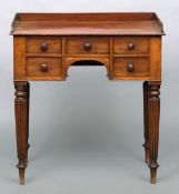 An early Victorian mahogany lowboy The three quarter galleried top above an arrangement of five