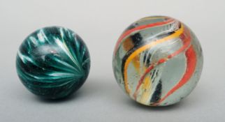 Two 19th century hand blown marbles The largest 4 cms diameter. (2)Some surface wear, overall good.