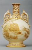 A Royal Worcester gilt decorated ivory ground vase The pierced neck above dolphin mask headed