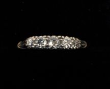 A five stone diamond ring On a pierced scroll setting.