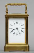 A 19th century brass cased carriage clock The white enamelled dial with Roman numerals and Arabic