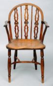 A 19th century yewwood and elm Uttoxeter Windsor chair The curved top rail above three turned and