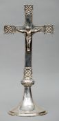 A Continental unmarked white metal crucifix Typically modelled and standing on a knopped mounted