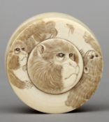 A late 19th/early 20th century carved ivory box and cover Decorated with monkeys. 6.5 cms diameter.
