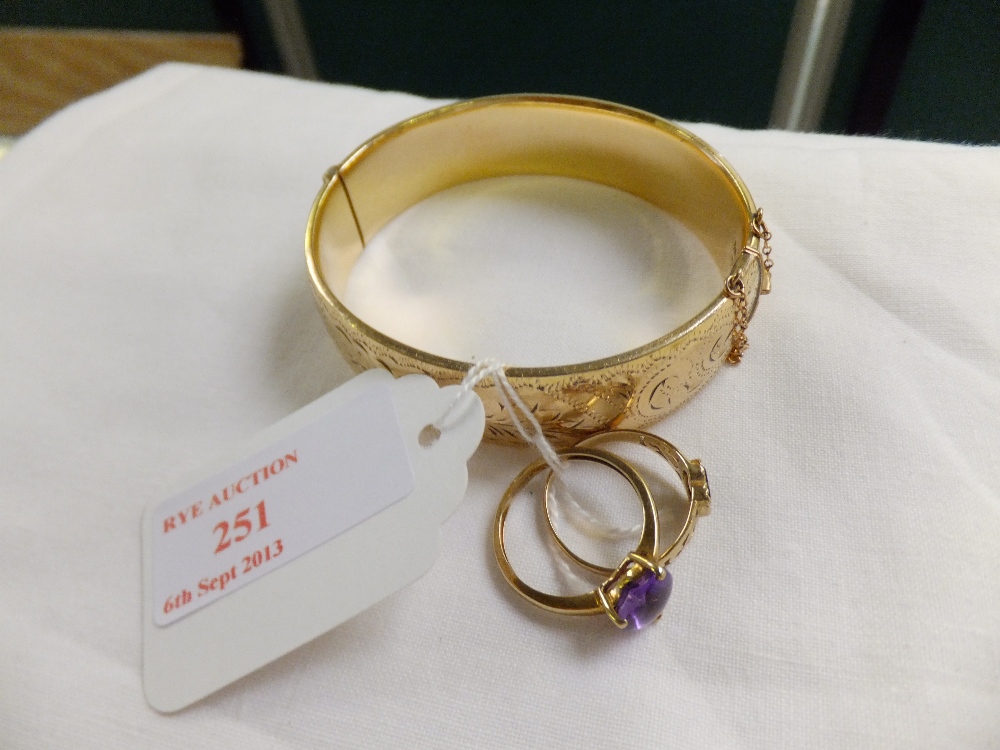 Two gold stone set rings and a rolled gold bracelet