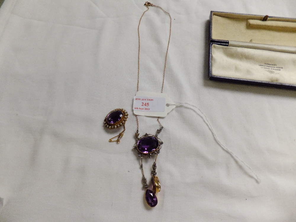 A gold pendant set with diamonds and amethyst together with a similar brooch