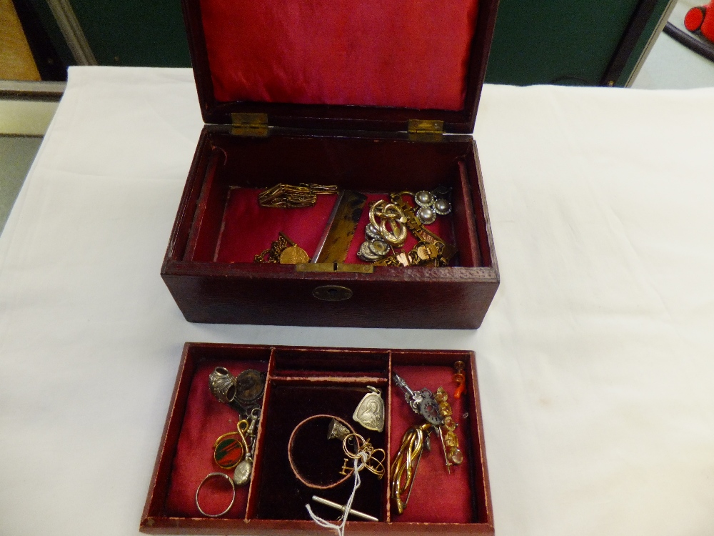 A leather jewellery box containing a mixed selection of jewellery