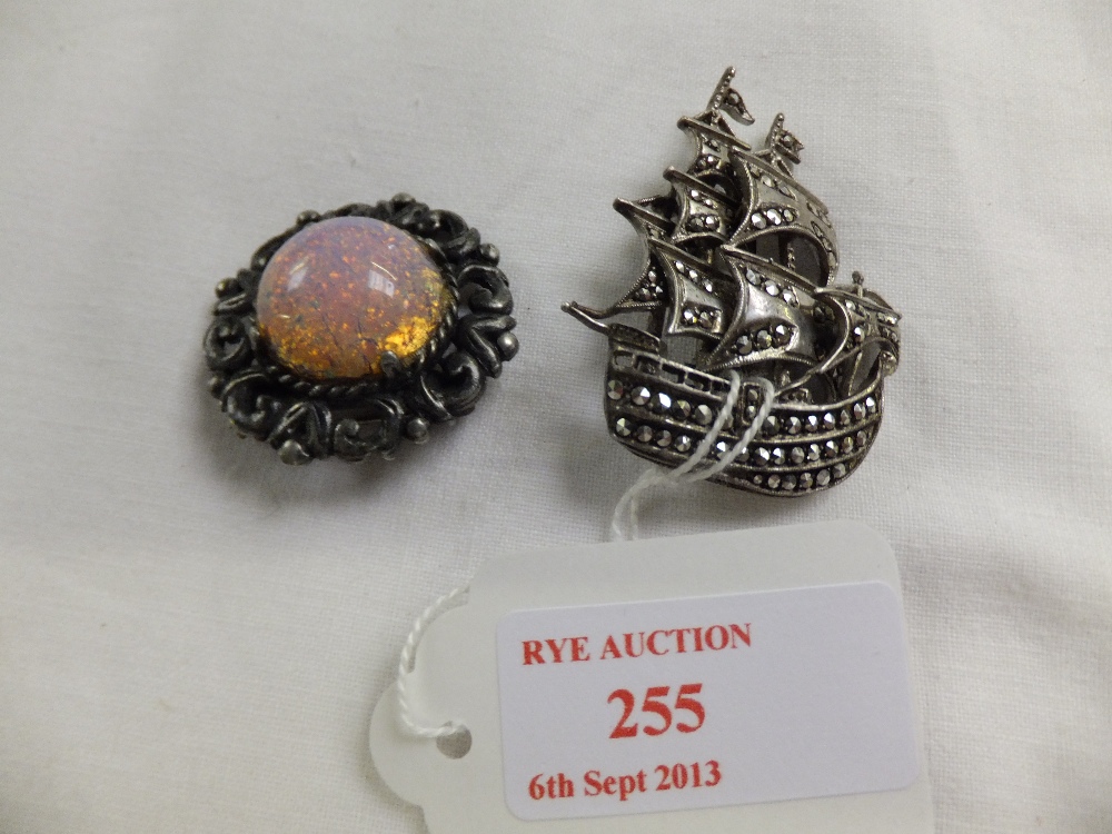 A silver and marquisette galleon brooch and an opal style brooch