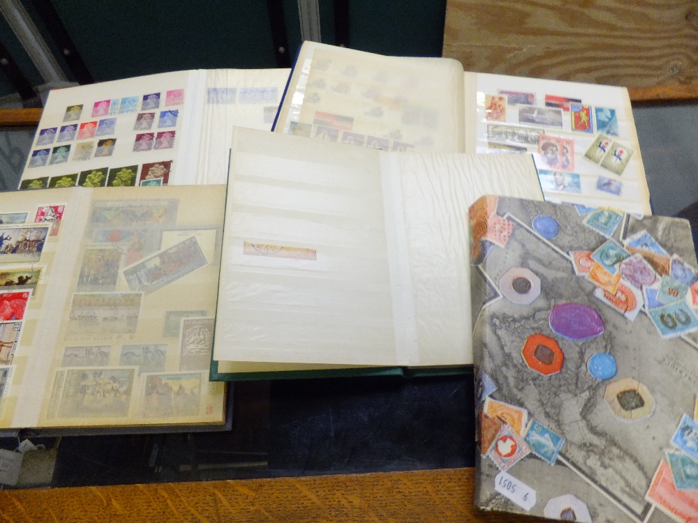 A group of five stamp albums containing stamps of the world