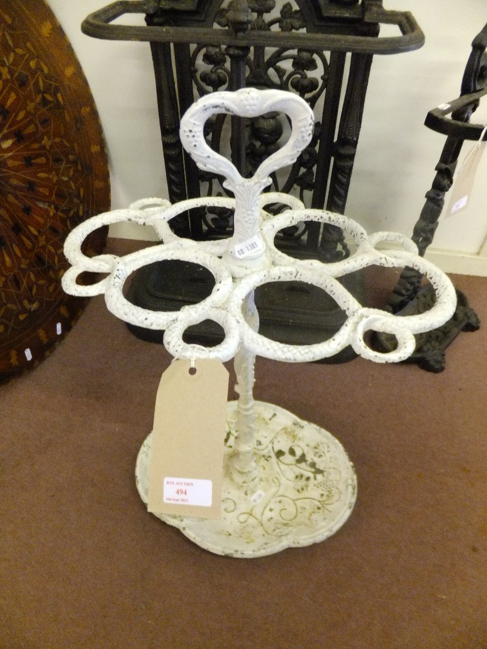 A white painted iron stick stand