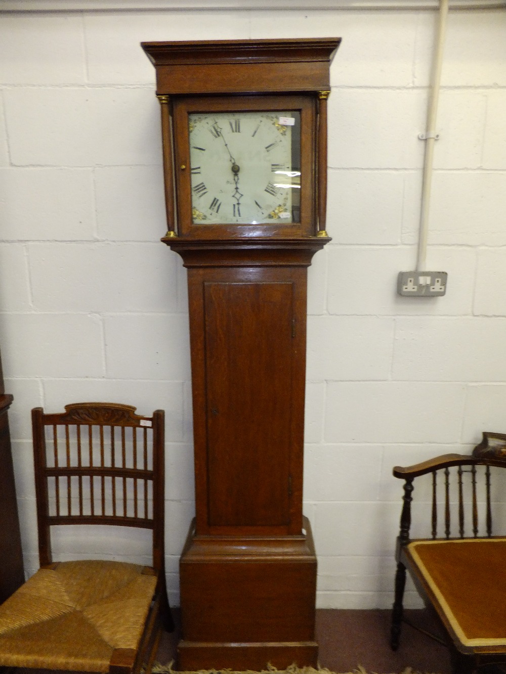 A 19th C oak long case clock, having 30 hour chiming movement and indistinctly signed painted dial