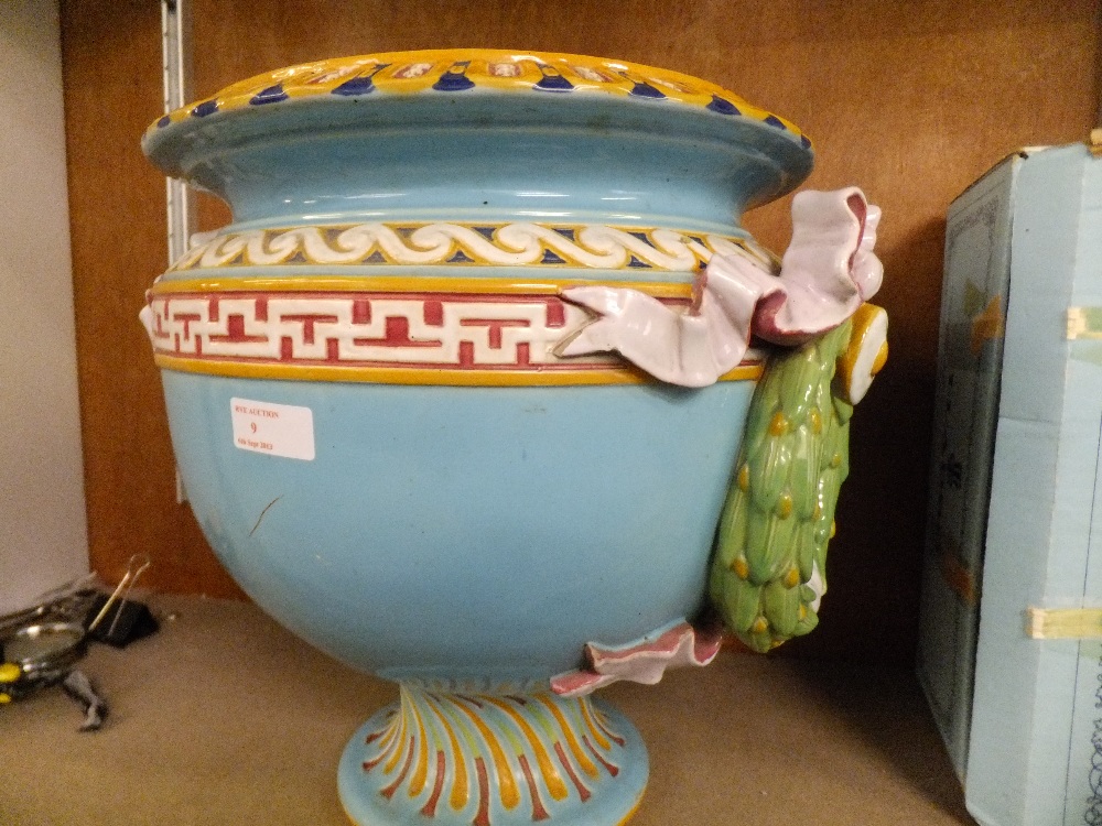 A Minton Majolica jardiniere with yellow, green and red tones on a turquoise ground with applied