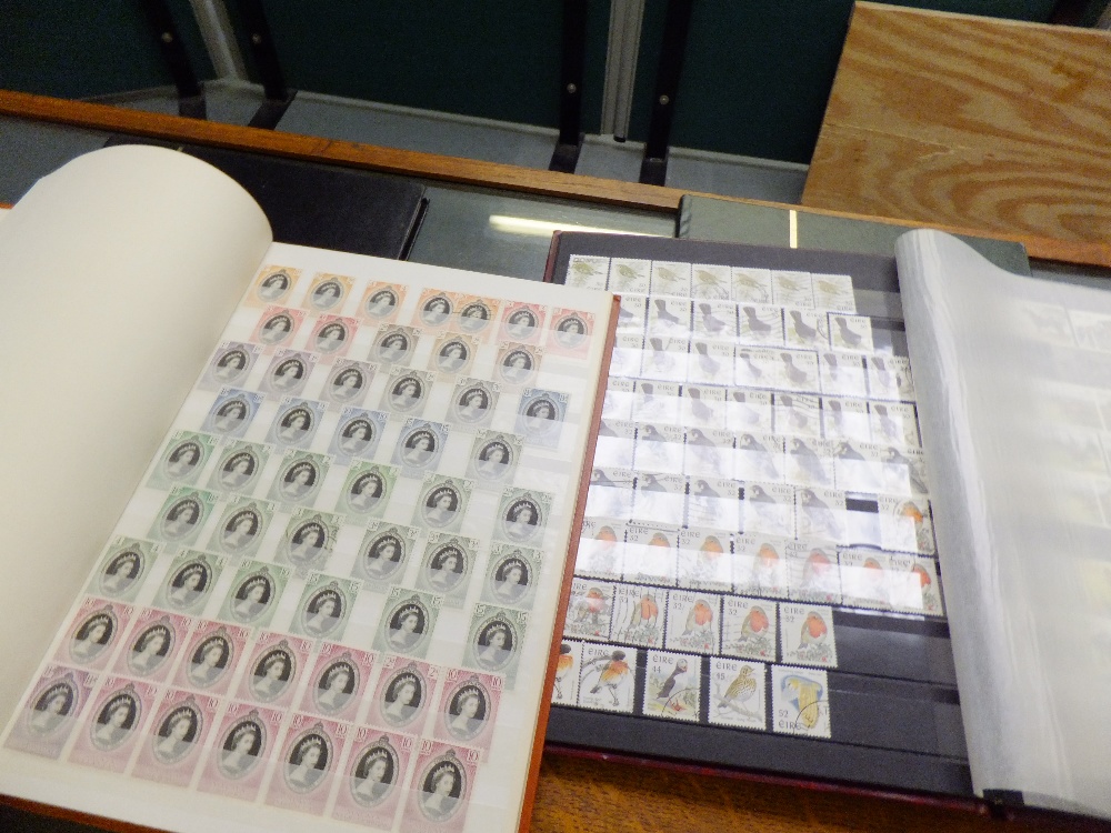 A group of four stamp albums containing a mixed selection of stamps from around the world