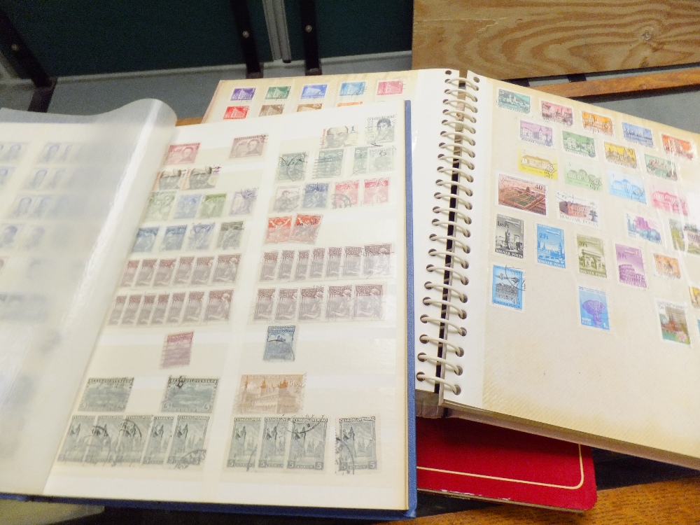 A group of four stamp albums containing stamps of the world