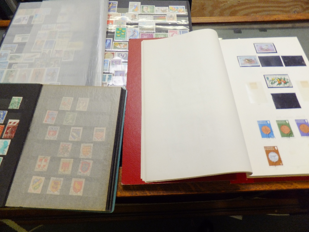 A group of three stamp albums containing stamps from the Isle of Man, Finland and France