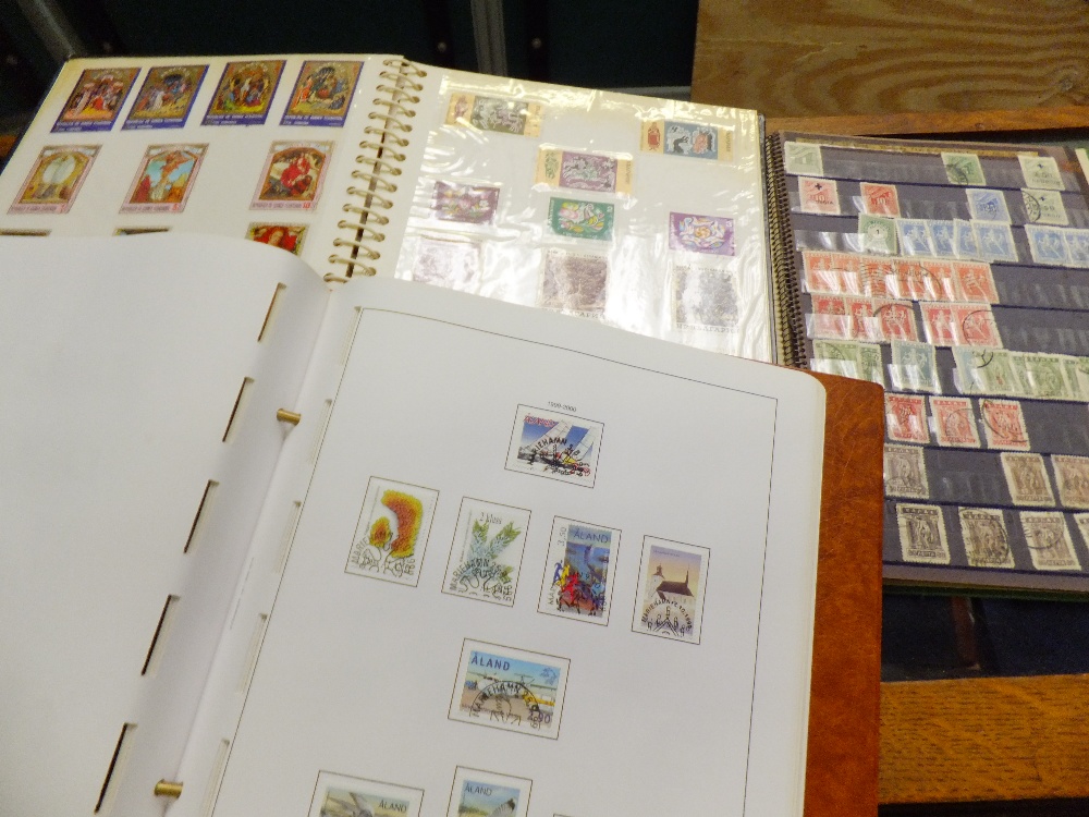 A group of three stamp albums containing stamps from Hungary, Aland and Greece