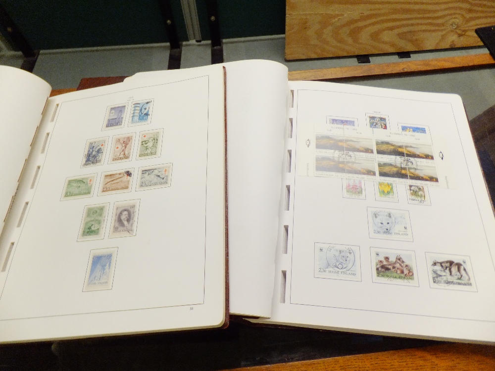 Two stamp albums containing stamps from Finland
