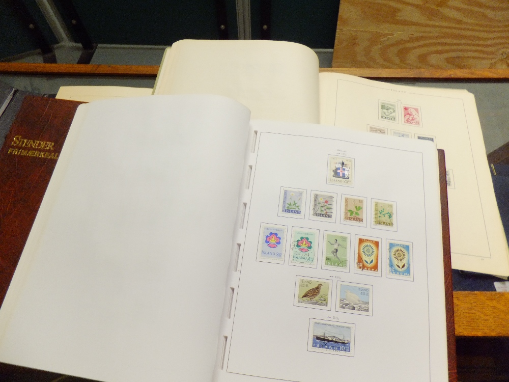 A group of three stamp albums containing stamps from Finland, Island and Iceland