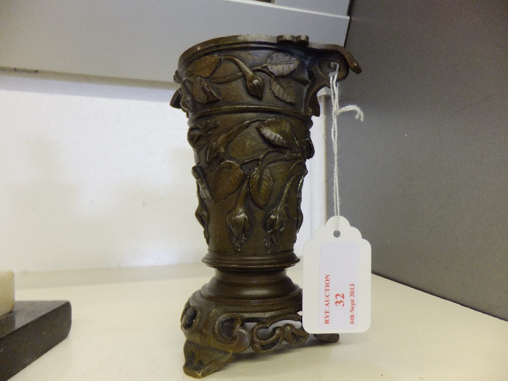 A bronze chalice with embossed floral decoration