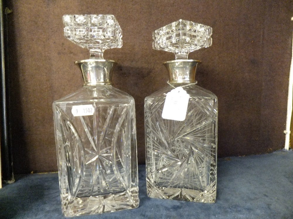 A pair of London 1978 silver collared lead crystal decanters