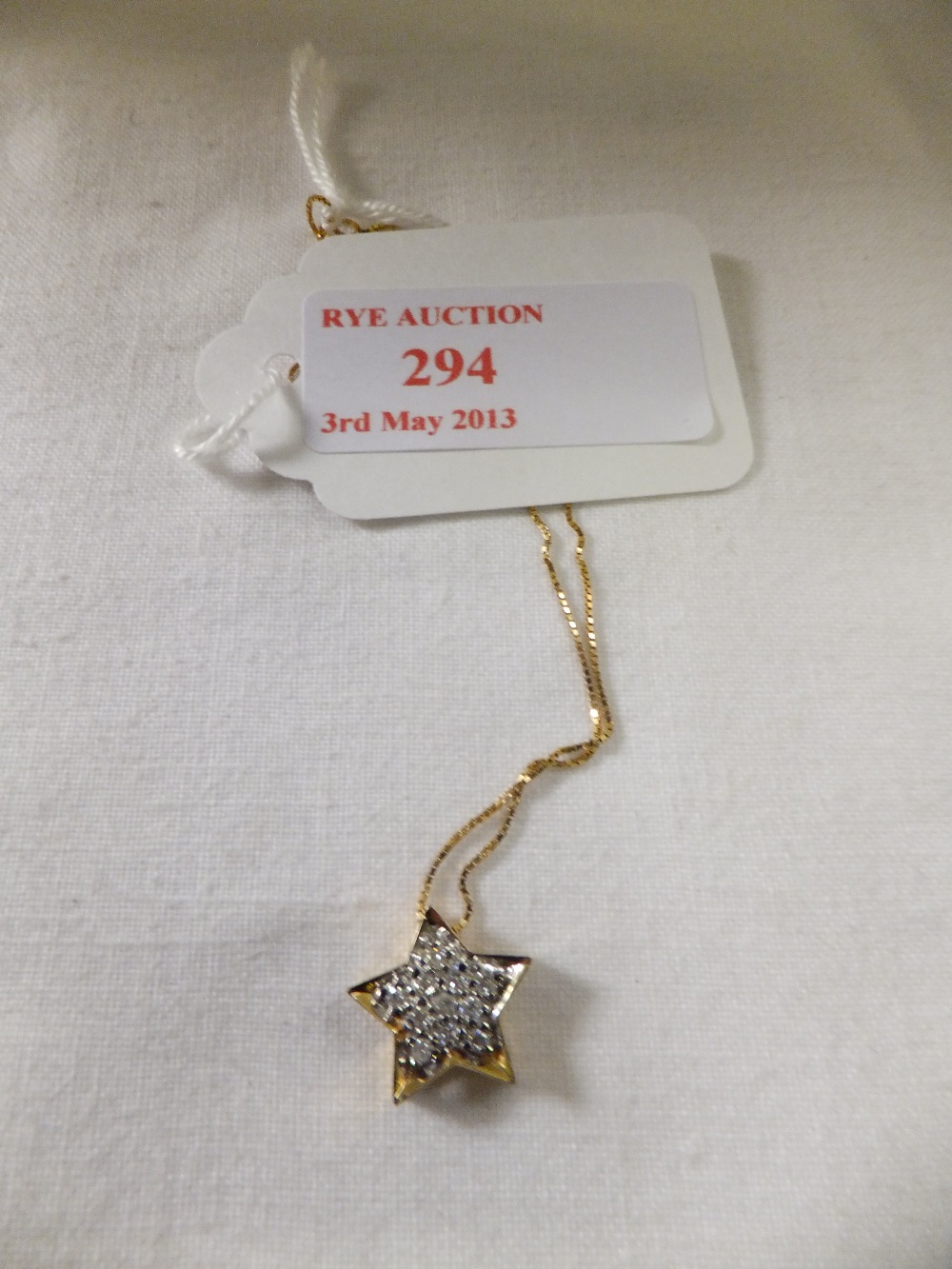 An 18ct gold "star" pendant on a 16" 9ct gold chain