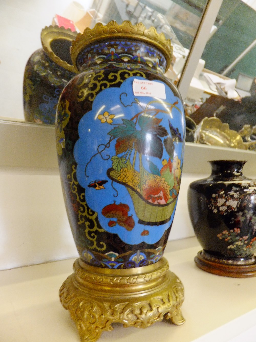 A  19 century Cloisonne vase with pictorial lozenge panels resting on a gilt base