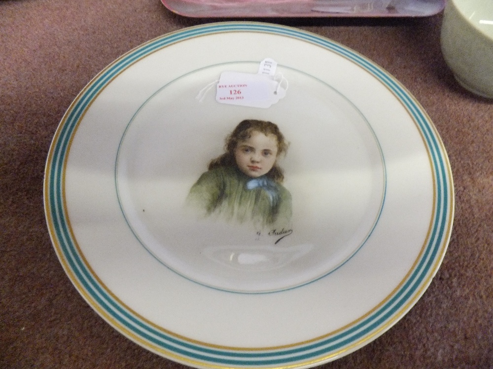 A 19 century French plate with central portrait of a child signed.