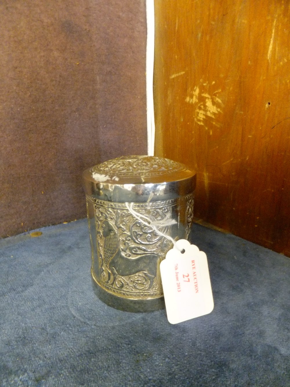 An Eastern silver caddy with embossed animal decoration